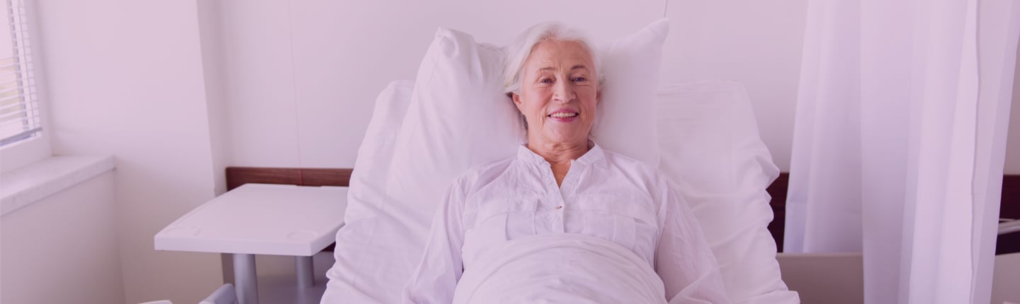 female patient resting in hospital bed after pressure injury prevention and treatment